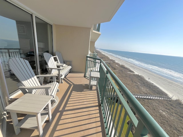 balcony with a beach view and a water view