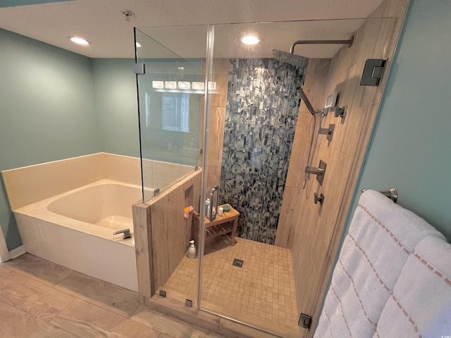 bathroom with a bath and a shower stall