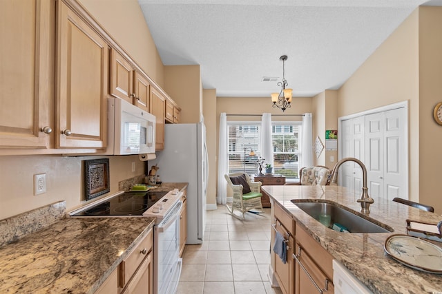 kitchen with white appliances, visible vents, stone counters, a sink, and pendant lighting