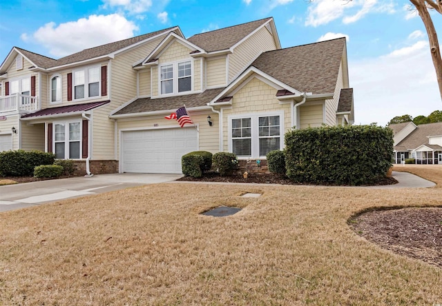 view of front of property featuring a front yard, a garage, driveway, and roof with shingles