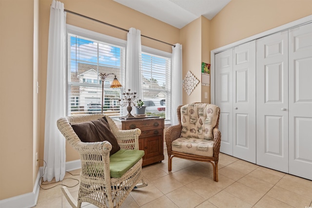 sitting room featuring light tile patterned floors and baseboards