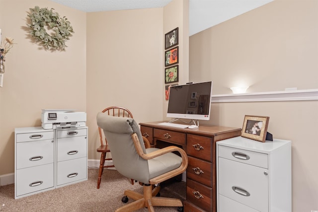 carpeted office space featuring baseboards