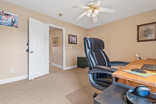 office area featuring carpet flooring, baseboards, and ceiling fan