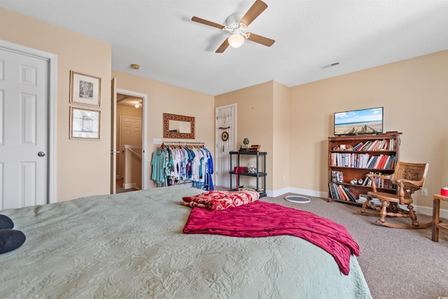 bedroom featuring carpet flooring, visible vents, baseboards, and a ceiling fan