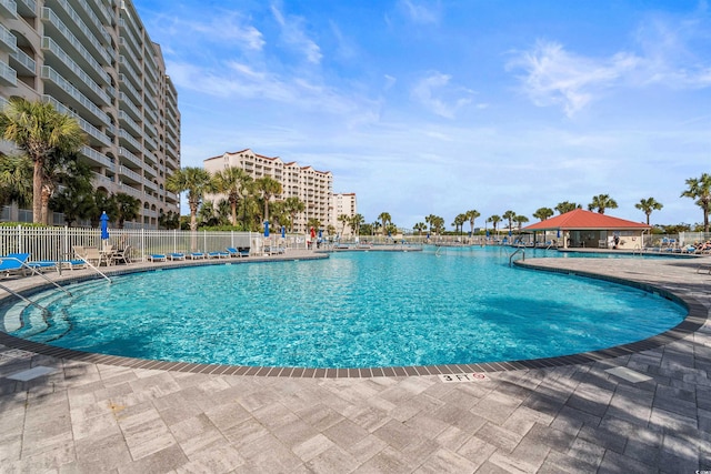 community pool featuring a patio area and fence