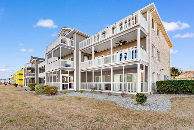 back of house featuring a balcony, ceiling fan, and a sunroom