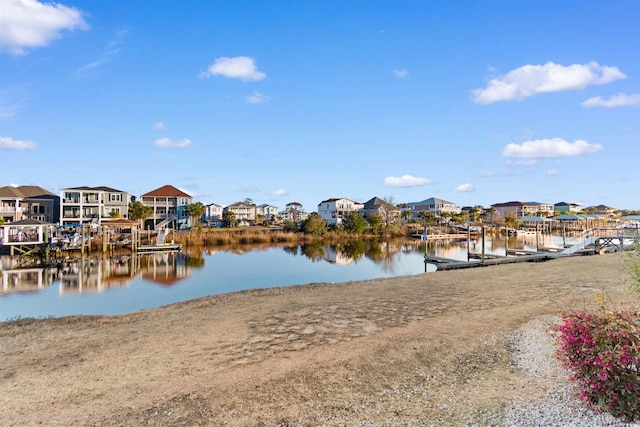 view of dock featuring a residential view and a water view