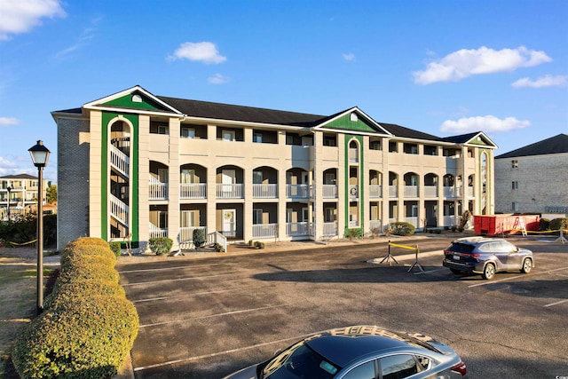 view of building exterior with uncovered parking