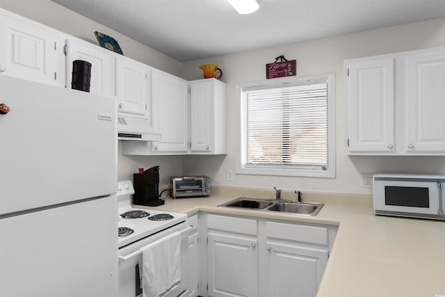 kitchen with a sink, light countertops, under cabinet range hood, white appliances, and white cabinetry