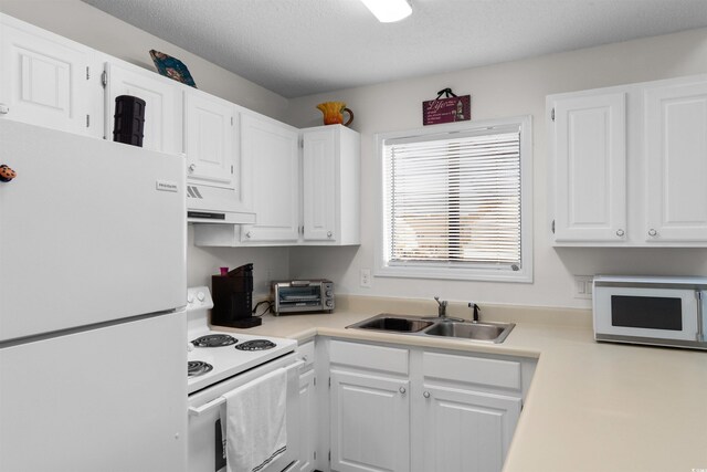 510 Fairwood Lakes Dr Unit 18-P, Myrtle Beach, SC 29588 - kitchen with a sink, light countertops, under cabinet range hood, white appliances, and white cabinetry