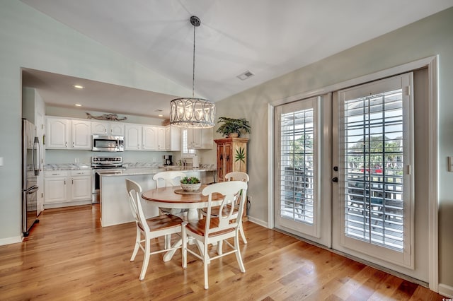 dining room with light wood finished floors, visible vents, a chandelier, vaulted ceiling, and recessed lighting