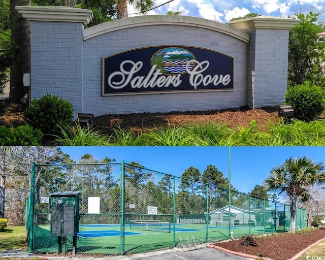 community sign featuring a gate and fence