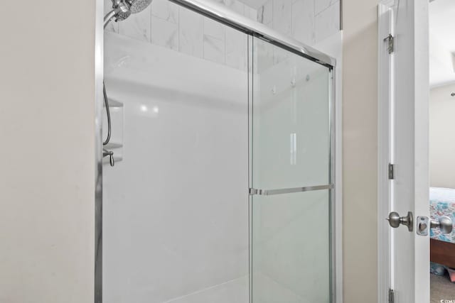 bathroom featuring a shower stall and ensuite bathroom