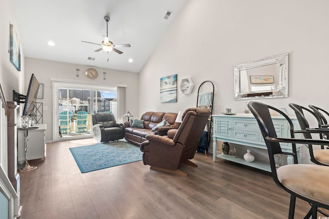 living area with visible vents, high vaulted ceiling, ceiling fan, and wood finished floors