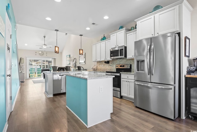 kitchen with decorative backsplash, ceiling fan, white cabinetry, and stainless steel appliances