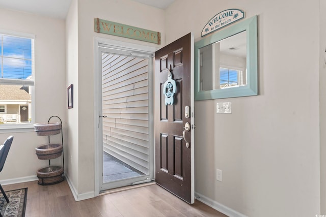 entrance foyer featuring wood finished floors and baseboards