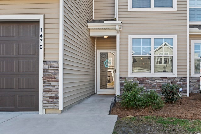 doorway to property with stone siding