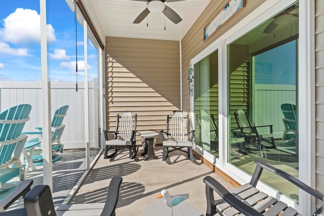 sunroom featuring a ceiling fan