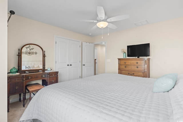 bedroom with carpet flooring, visible vents, a closet, and ceiling fan