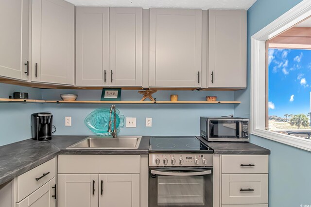 2710 S Ocean Blvd Unit 404, Myrtle Beach, SC 29577 - kitchen with a sink, appliances with stainless steel finishes, open shelves, and white cabinetry
