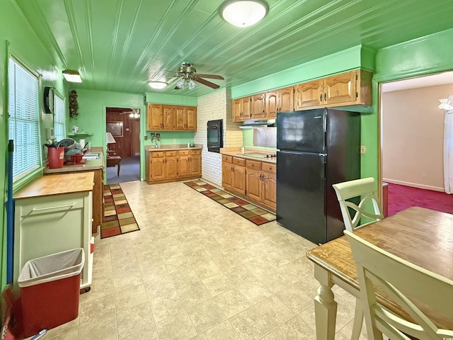 kitchen with ceiling fan, black appliances, light countertops, wood ceiling, and under cabinet range hood