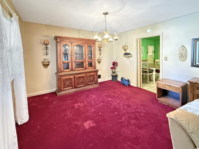 sitting room with an inviting chandelier, carpet flooring, and baseboards