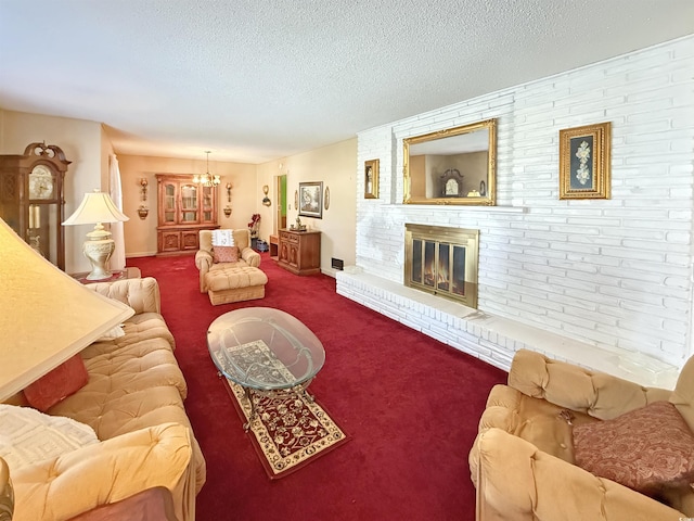 carpeted living room with a textured ceiling, an inviting chandelier, and a fireplace