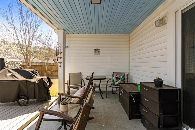 view of patio / terrace with a deck and fence