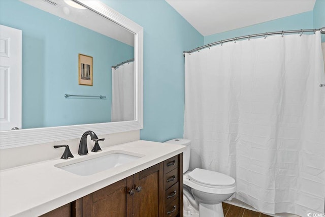 full bath with vanity, curtained shower, toilet, and wood finished floors