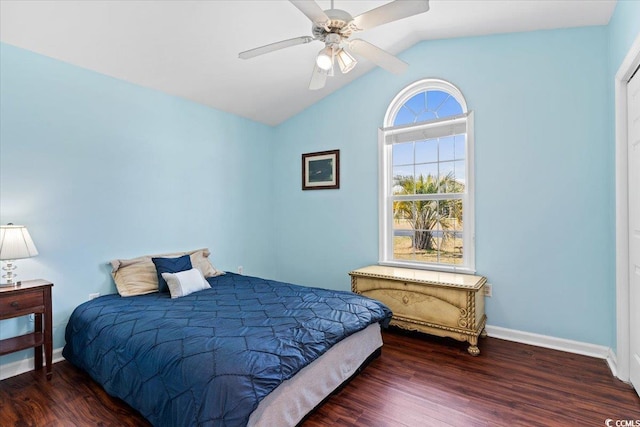 bedroom with ceiling fan, baseboards, lofted ceiling, and wood finished floors