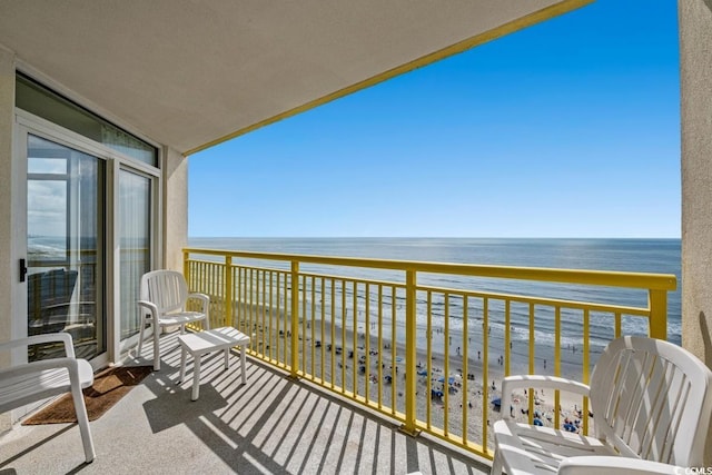 balcony with a water view and a beach view