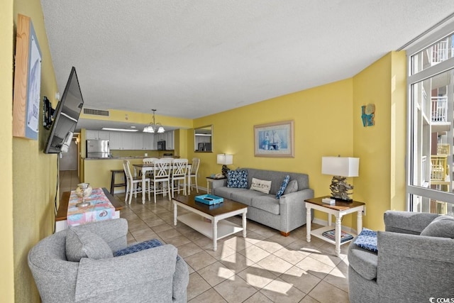 living area with light tile patterned floors and a textured ceiling