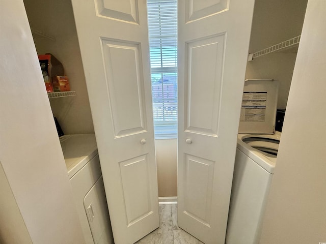 washroom with washer / clothes dryer, marble finish floor, and laundry area