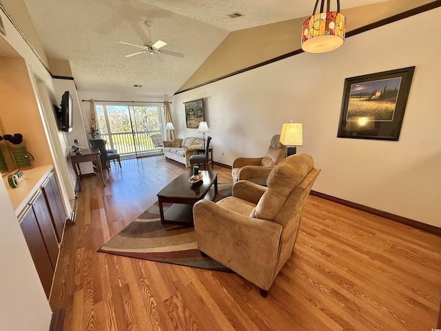 living room with baseboards, visible vents, lofted ceiling, ceiling fan, and light wood-type flooring