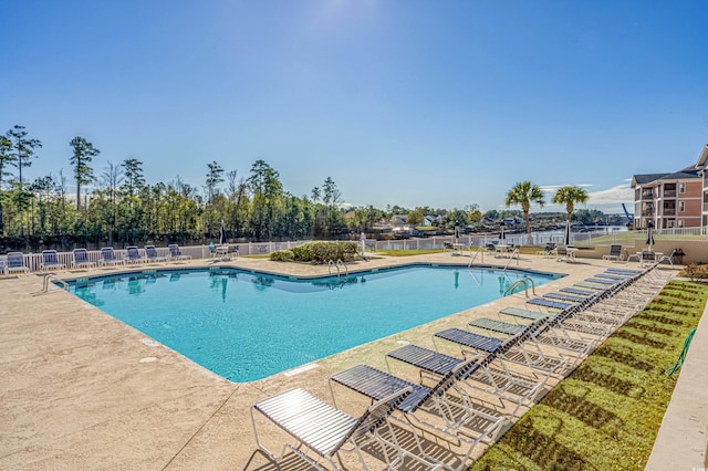 community pool featuring a patio and fence