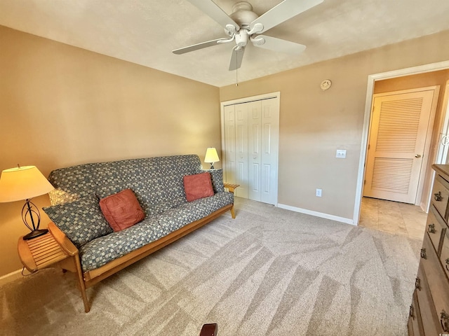 sitting room with carpet flooring, baseboards, and ceiling fan