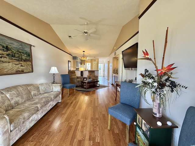 living room with lofted ceiling, wood finished floors, visible vents, and ceiling fan