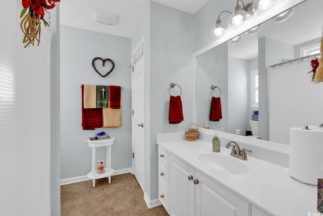 full bathroom featuring tile patterned floors, toilet, vanity, and baseboards