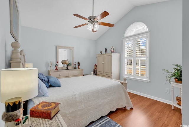 bedroom featuring vaulted ceiling, a ceiling fan, baseboards, and wood finished floors