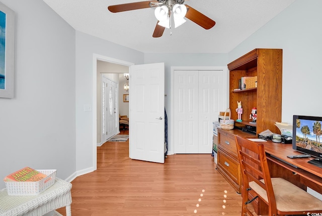 office with a ceiling fan, light wood-style floors, and baseboards