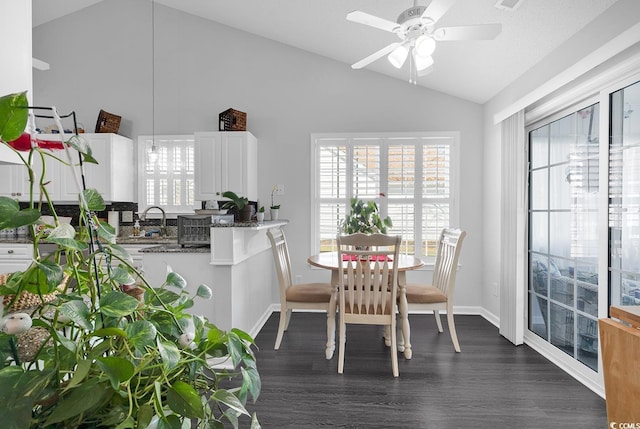 dining space with visible vents, dark wood-type flooring, ceiling fan, baseboards, and lofted ceiling