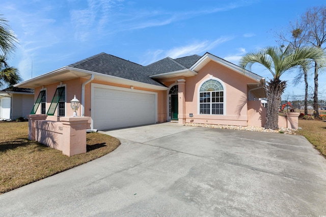 single story home with stucco siding, a garage, concrete driveway, and a shingled roof