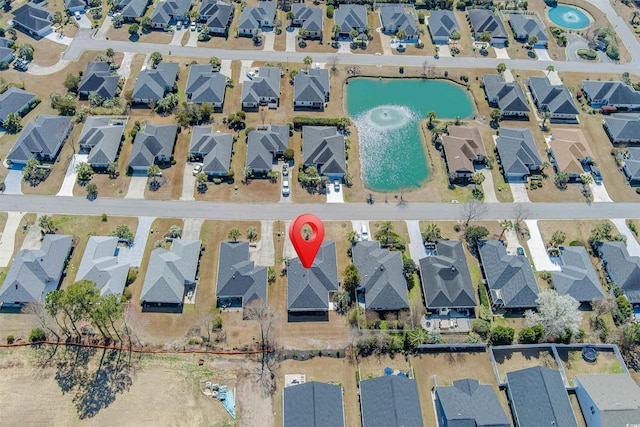 bird's eye view featuring a residential view and a water view