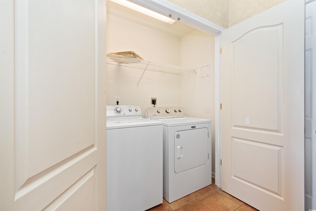 laundry area with laundry area, light tile patterned flooring, and washer and clothes dryer