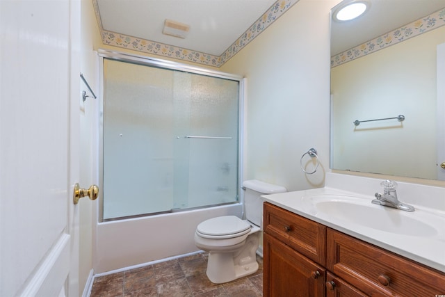 bathroom featuring enclosed tub / shower combo, toilet, and vanity