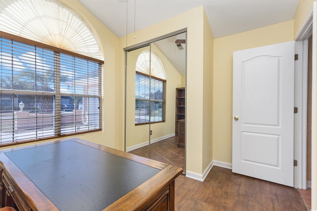 game room featuring baseboards and dark wood-style flooring