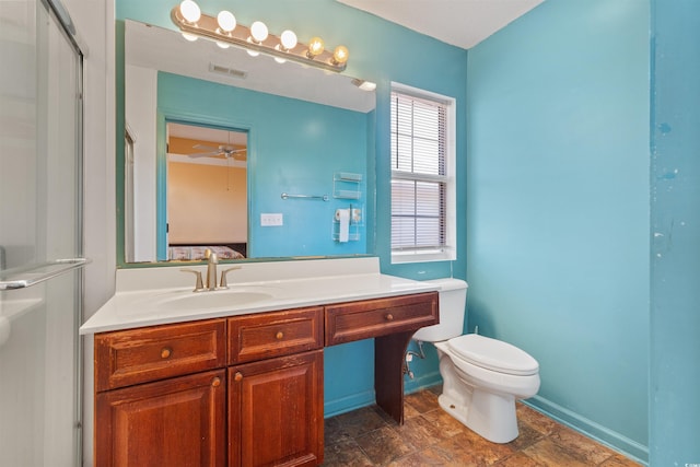 bathroom with visible vents, toilet, baseboards, ceiling fan, and vanity