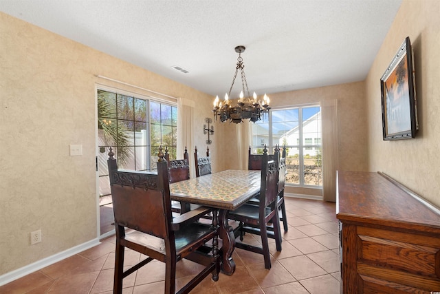 dining space with a chandelier, visible vents, baseboards, and light tile patterned flooring