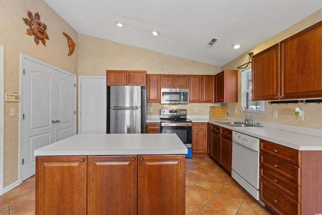 kitchen with light tile patterned floors, visible vents, lofted ceiling, a sink, and appliances with stainless steel finishes