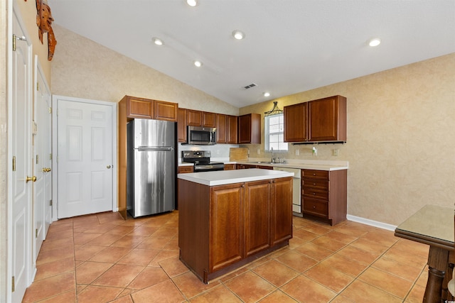 kitchen featuring a sink, stainless steel appliances, light countertops, vaulted ceiling, and a center island